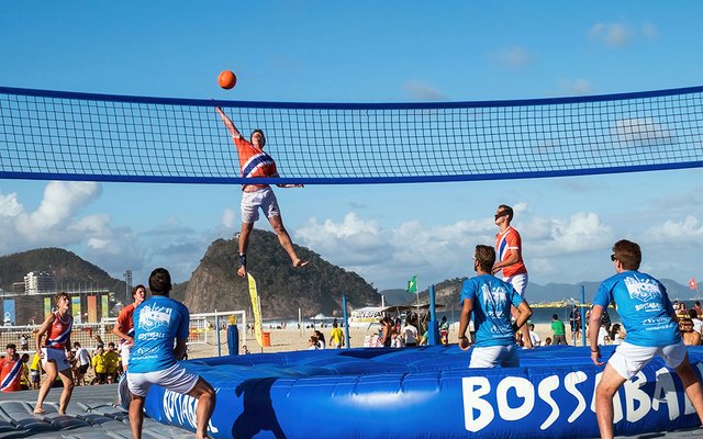 In Bossaball, players throw a ball over a net while jumping on large trampolines.